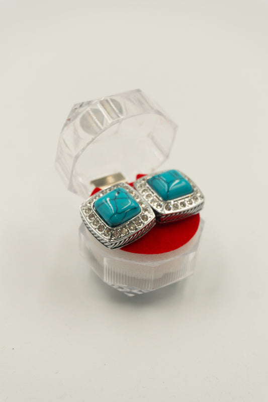 Mancuernilla plateada con piedra celeste y orilla de imitación diamante - MAN - 017